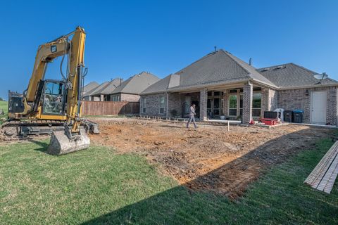 An excavator digging in the backyard of a house