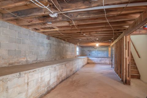 An unfinished basement with concrete block foundation walls